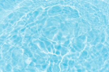 Obraz premium Blue water with ripples on the surface. Defocus blurred transparent blue colored clear calm water surface texture with splashes and bubbles. Water waves with shining pattern texture background.