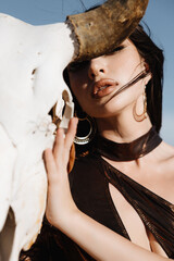 girl in a swimsuit in the desert, fashion beauty girl in the desert, A girl holds a buffalo skull