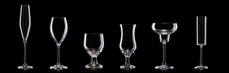 Set of different empty glasses for drinks and cocktails on black background
