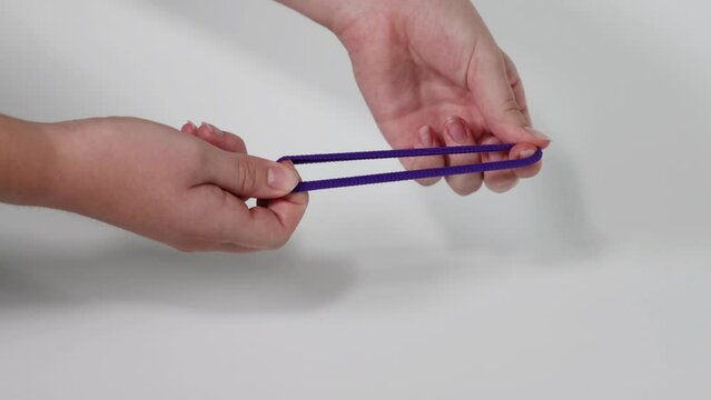 Hands Stretching Purple Hair Tie
