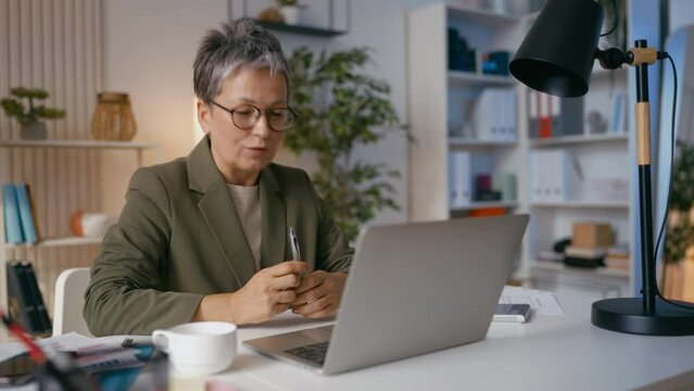 Businesswoman has video call on laptop, communicates with business partners