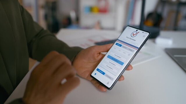 Close-up of a woman using online voting app on cellphone, choosing a candidate