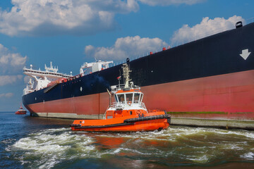 Fototapeta premium Port of Gdansk, Poland, a large tanker PEARY SPIRIT enters the port, accompanied by the port tug VEGA