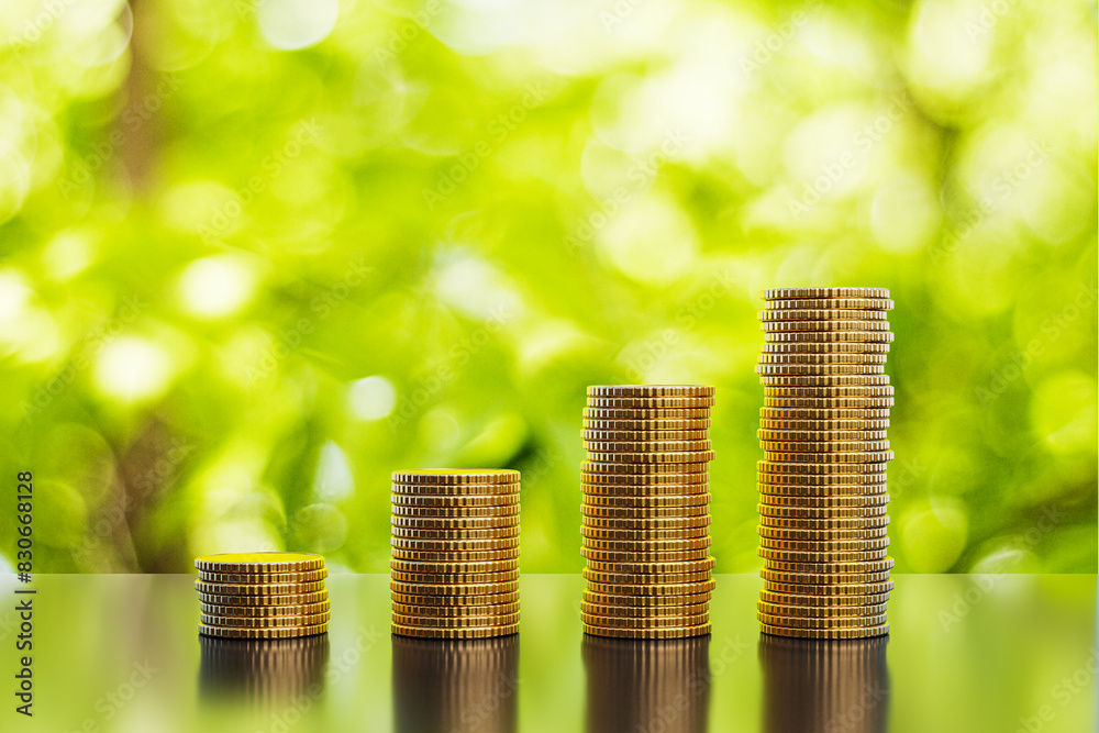 Leinwandbilder abstract growing stacked coins on blurry green background with mock up place. financial growth and f