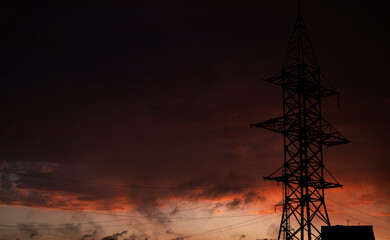 High-voltage electric power lines at sunset.
