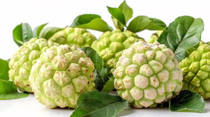 Fototapeta premium Tropical fruit with green foliage on white backdrop.