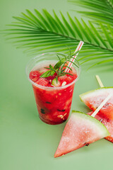 Refreshing watermelon cocktail. Traditional summer drink. Trendy Savannah green background