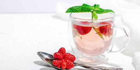 Strawberry tea concept. Good morning concept. Teapot, ripe fruits, healthy beverage