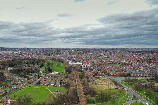 Aerial photo of the village of Kirkstall in the Leeds city centre in the UK over looking rows of terrace houses and a train track viaduct in the West Yorkshire city centre
