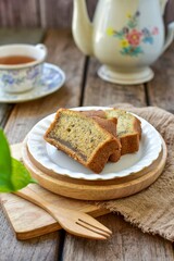 Banana cake with hot tea , set afternoon tea on wooden blackground,