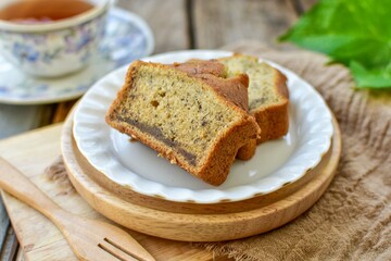 Banana cake with hot tea , set afternoon tea on wooden blackground,