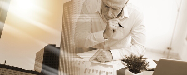 Businessman analysing marketing graphs; multiple exposure