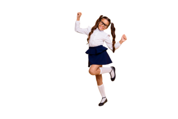 I'm happy because I'm going back to school! Full length, legs, body, size portrait of small girl isolated on bright yellow background stands on one leg raised her hands up