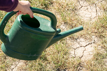 Watering a drought soil, Close-up of the dry, cracked earth, Ground and crack soil into the dry season