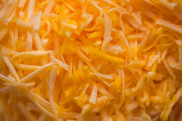 Grated fresh raw pumpkin prepared for cooking. Healthy vegetarian food ingredient.