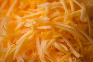 Grated fresh raw pumpkin prepared for cooking. Healthy vegetarian food ingredient.
