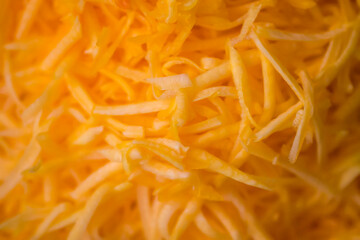 Grated fresh raw pumpkin prepared for cooking. Healthy vegetarian food ingredient.