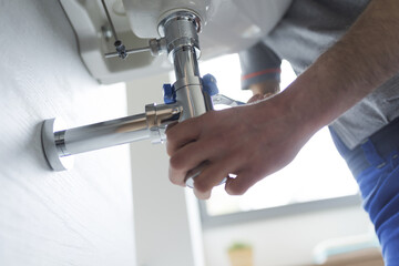 Professional plumber fixing a faulty sink