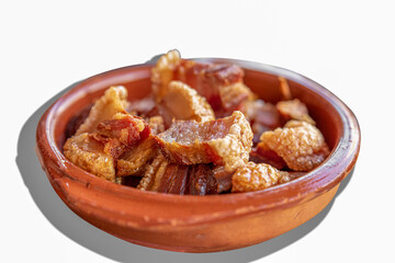 Crispy fried pork belly, torreznos with white background