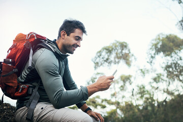 Phone, chat and hiking man in forest with backpack for fitness, training and location, search or...