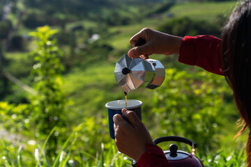 Making drip coffee with a beautiful mountain and nature view in background