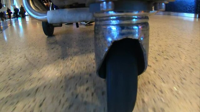 Close-Up Time Lapse Shot Of Wheel Of Luggage Cart Moving At Airport - Los Angeles, California