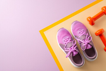 Overhead shot of pink sneakers and red dumbbells on a colorful background, symbolizing fitness, exercise, and an active lifestyle