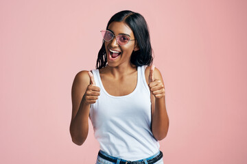Studio, Indian woman and thumbs up in portrait for agreement, success and support with mockup....