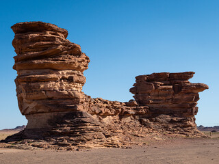 Weathered rock formations around Bajdah in the uniquely shaped landscape of Hisma mountain range in Tabuk Province, Saudi Arabia. Clear sky. Space for text.