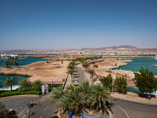 Looking across the waterfront of the luxury leisure development of Ayla on the Red Sea&rsquo;s Gulf of Aqaba in Jordan towards the mountains of southern Israel and the town of Eilat.