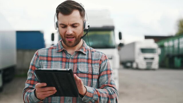 Having hard time reading the document in notepad. Man is standing against trucks outdoors.