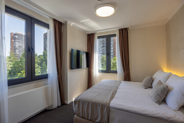 Interior of a luxury hotel double bed bedroom in the morning
