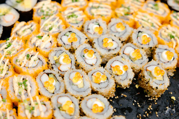 Maki sushi with shrimp eggs, buffet style, ready to be served to guests at the event.