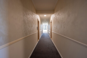 Interior of a carpeted hotel corridor doorway