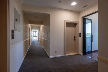 Interior of a carpeted hotel corridor doorway