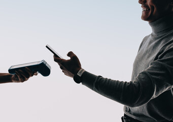 Happy customer uses mobile wallet to conveniently pay with a smartphone at POS