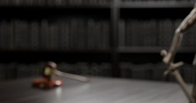 Legal Concept: Themis is the goddess of justice and the judge's gavel hammer as a symbol of law and order on the background of books