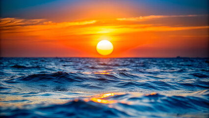 Obraz premium The sun is setting behind the sea