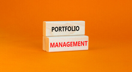 Portfolio management symbol. Concept words Portfolio management on beautiful wooden block. Beautiful orange paper background. Business Portfolio management concept. Copy space.