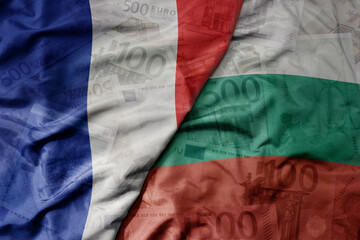 big waving realistic national colorful flag of bulgaria and national flag of france on a euro money...