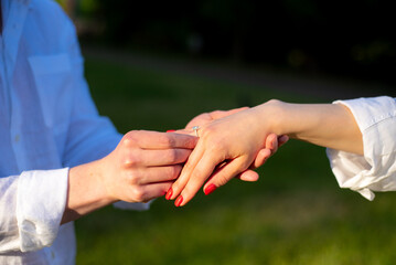 Bride and groom hands with wedding ring