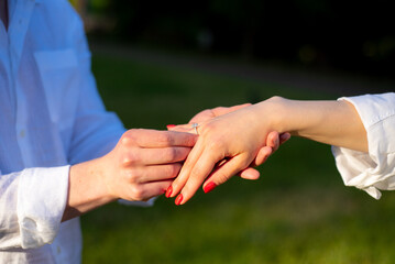 Bride and groom hands with wedding ring