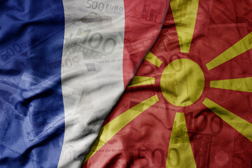 big waving realistic national colorful flag of macedonia and national flag of france on a euro...