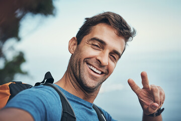 Outdoor, selfie and man with smile, hiking and peace on hill, travel and journey in woods or...