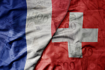 big waving realistic national colorful flag of switzerland and national flag of france on a euro...