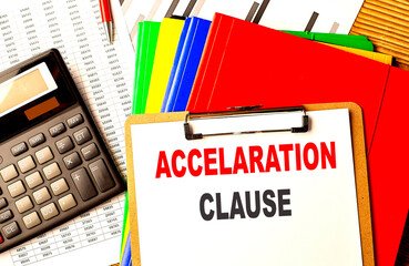 ACCELERATION CLAUSE text on clipboard with calculator and color folder