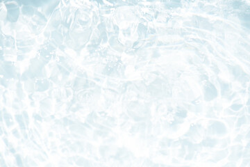 White water with ripples on the surface. Defocus blurred transparent white colored clear calm water surface texture with splashes and bubbles. Water waves with shining pattern texture background.
