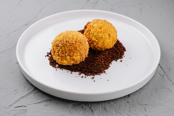 Gourmet truffles on white plate with cocoa dusting