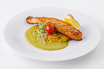Gourmet grilled salmon on a bed of green sauce