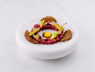 Deconstructed beef tartare with quail egg and rye bread